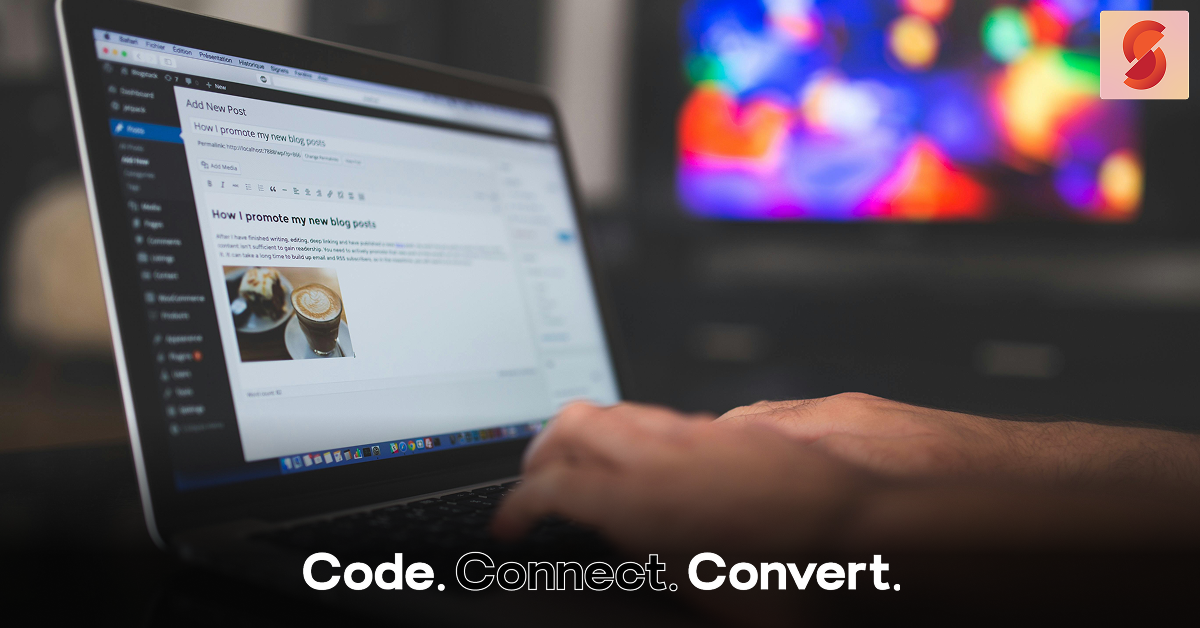 A close-up of a person typing on a laptop. The screen displays a blog post editor with the headline "How I promote my new blog post," with a colorful, blurred background.