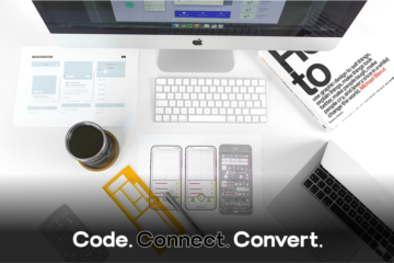 An overhead view of a clean, modern designer's desk featuring a computer, laptop, printed website layouts, and hand-drawn mobile app wireframes.