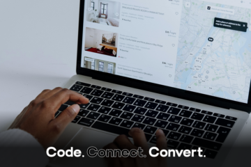 An over-the-shoulder view of a person's hands on a laptop keyboard, browsing a travel rental website that shows a list of properties and a city map.