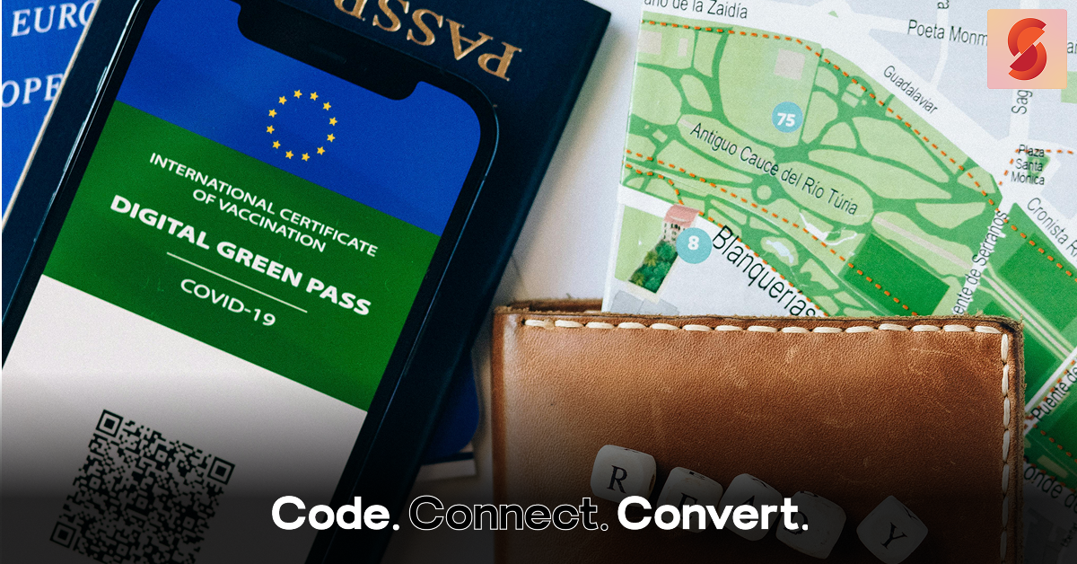 A flat lay of essential travel items, including a passport, a city map, and a smartphone displaying a COVID-19 "Digital Green Pass" vaccination certificate.